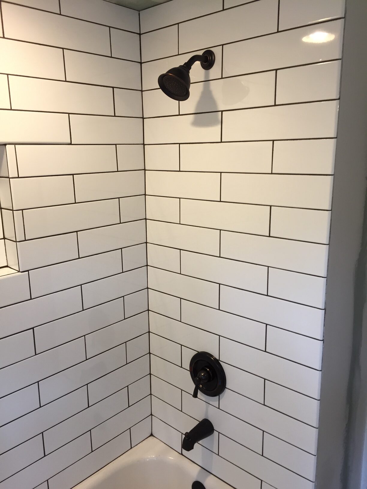 Bathroom subway tile black grout Steinmeyer General Contracting